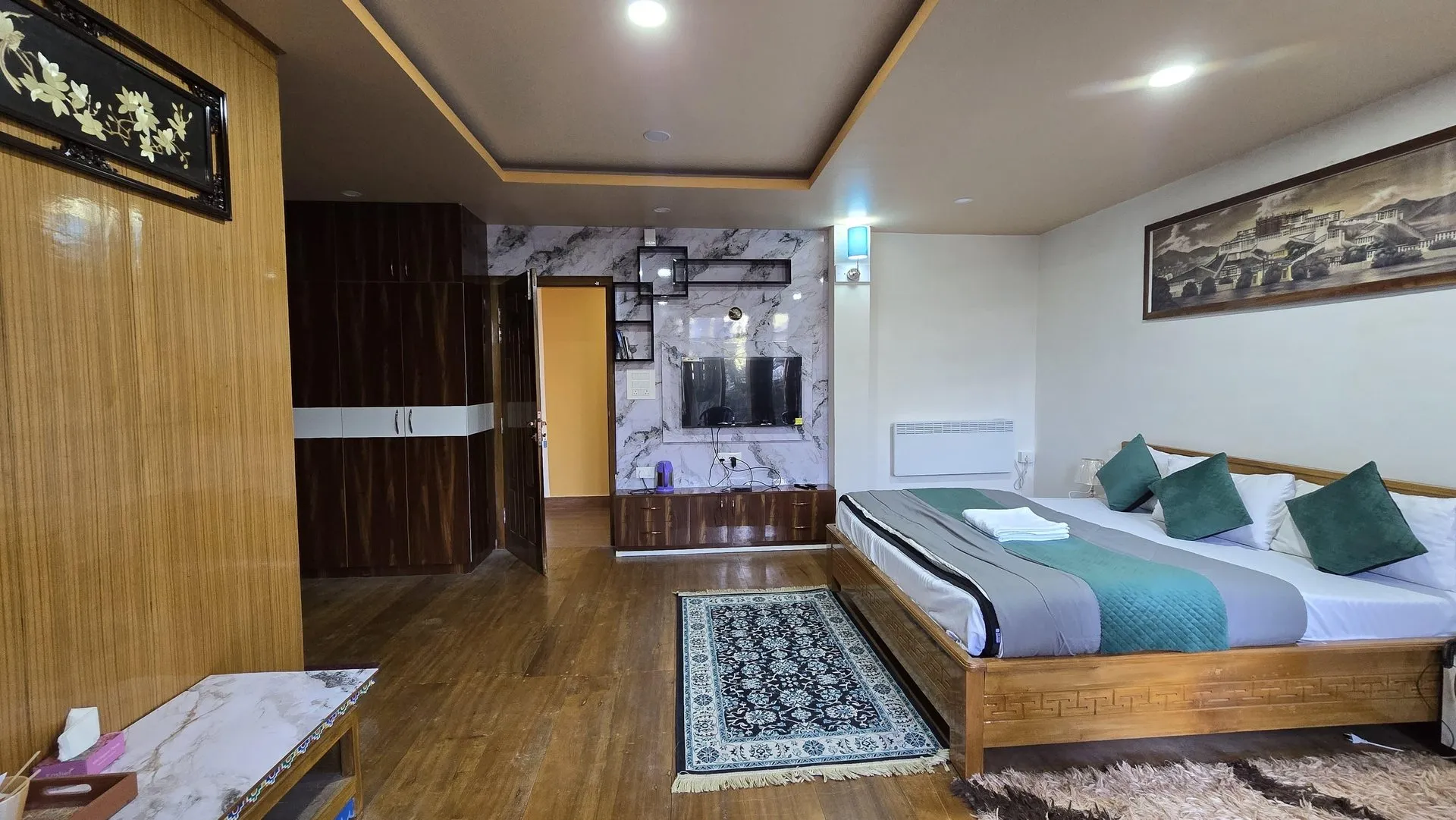 Premium Room at Rikya Retreat with a double bed and television