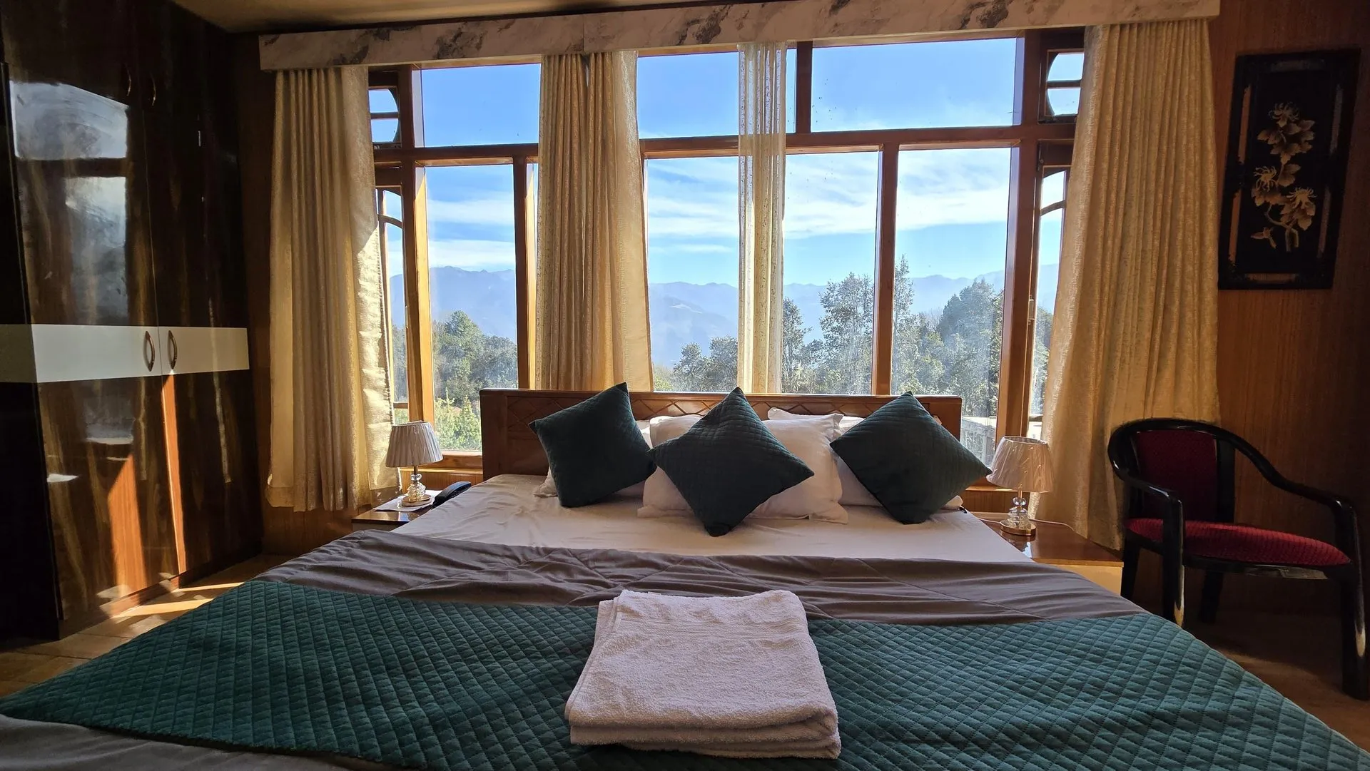 Super Premium Room bed with mountains visible through the window