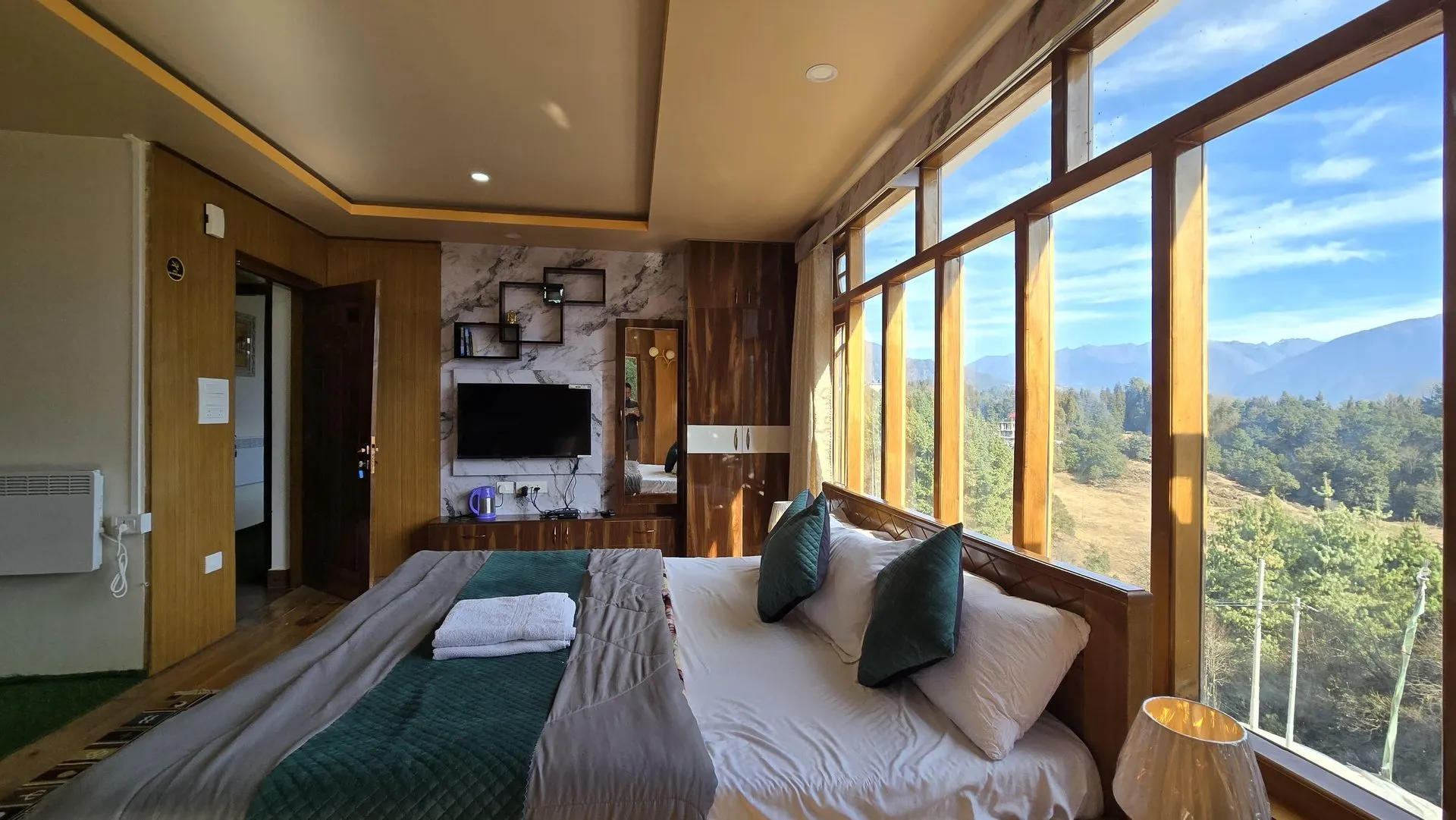 Window-side Super Premium Room interior with bed and television